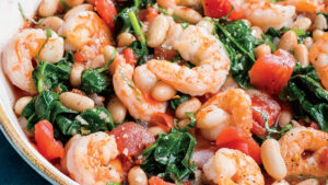 Garlic shrimp with white beans, greens and tomatoes