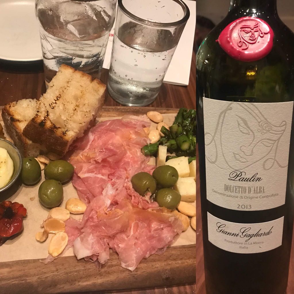 Bottle of wine and salami board
