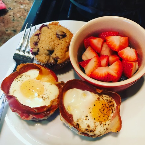 Egg cups with fruit and muffins