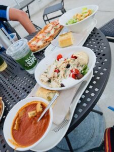 traveling with kids and road trip dining photo of tomato soup, ceasar salar, and pizza