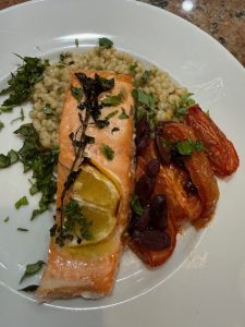 Salmon with slow roasted tomatoes and couscous and citrus oregano oil